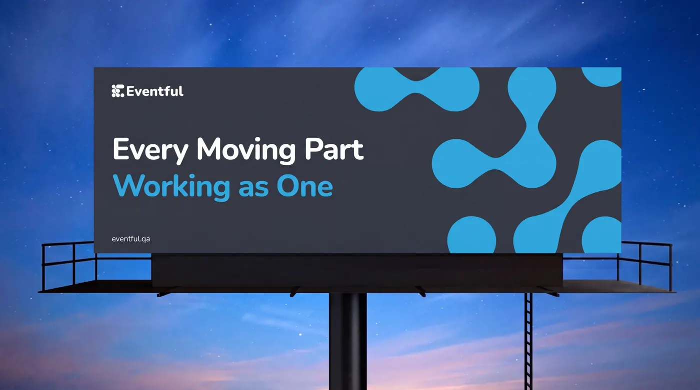 Eventful billboard reading Every Moving Part Working as One against an evening sky
